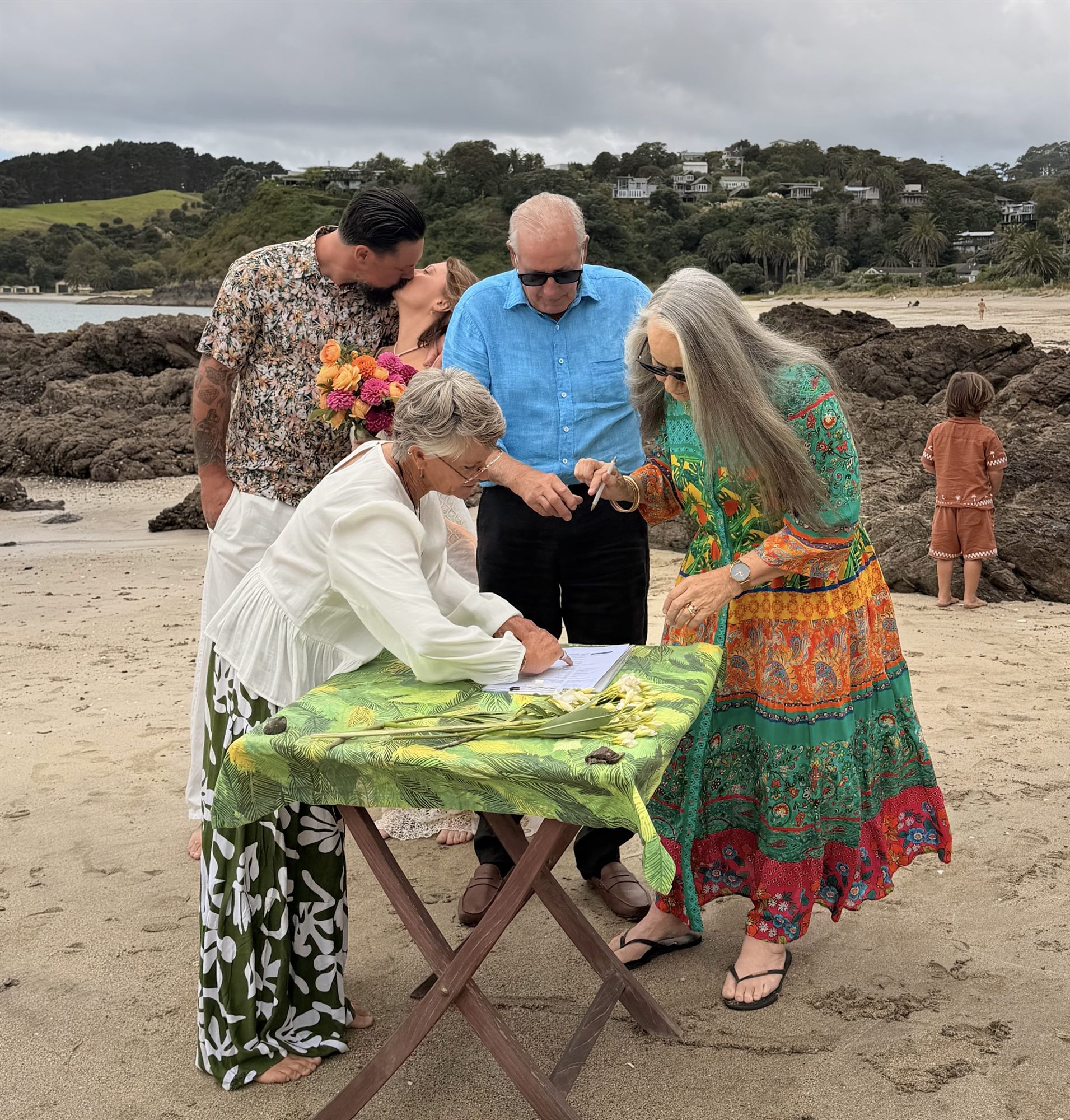 Signing the marriage register on the beach at Waiheke Island - casual beachside wedding