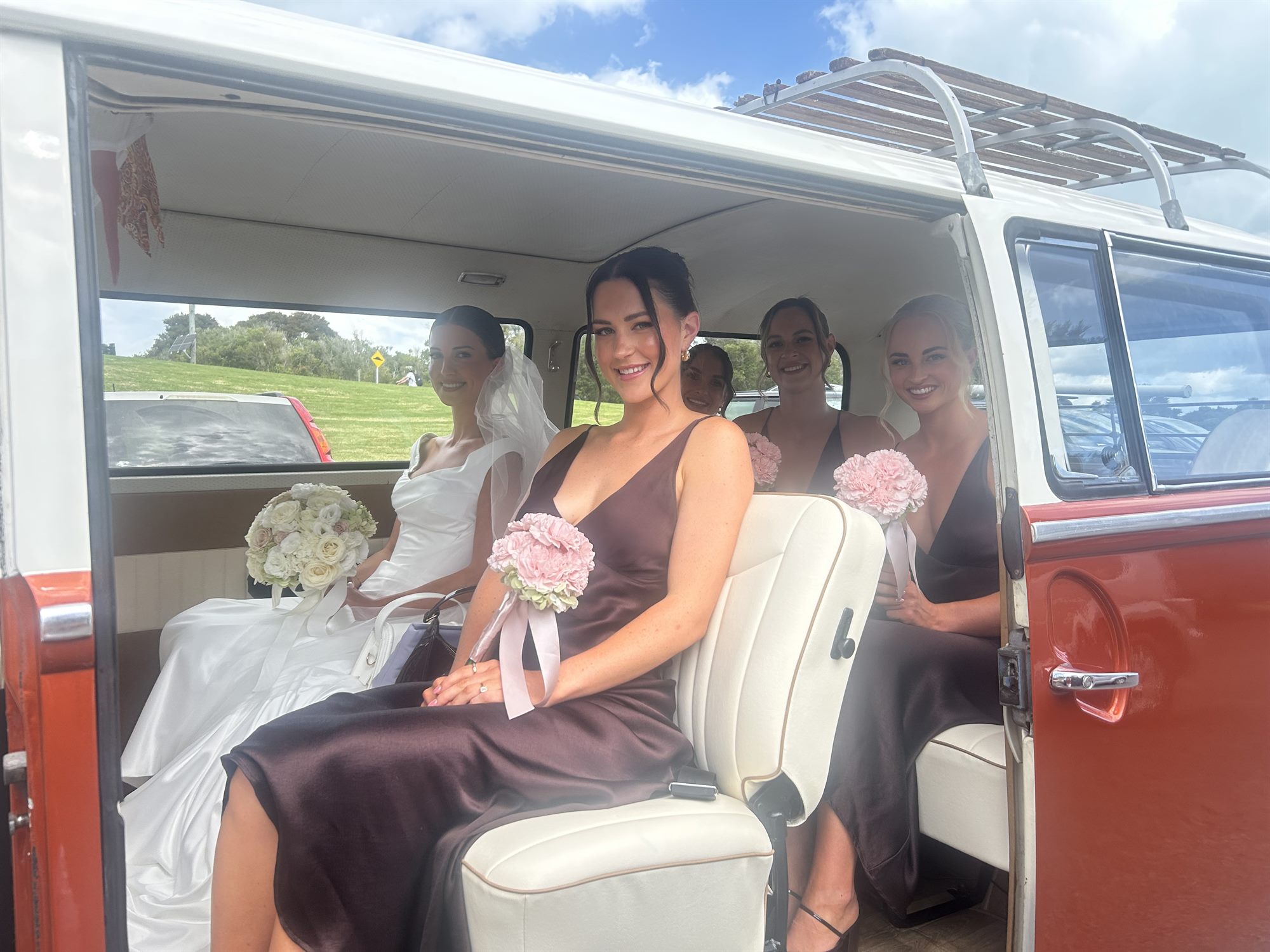 Bride and bridesmaids seated inside Solana the 1969 Kombi van, Waiheke Island