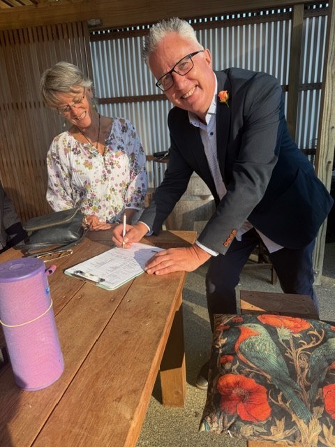 Carlos signing the marriage register at his Waiheke Island wedding with Lucy