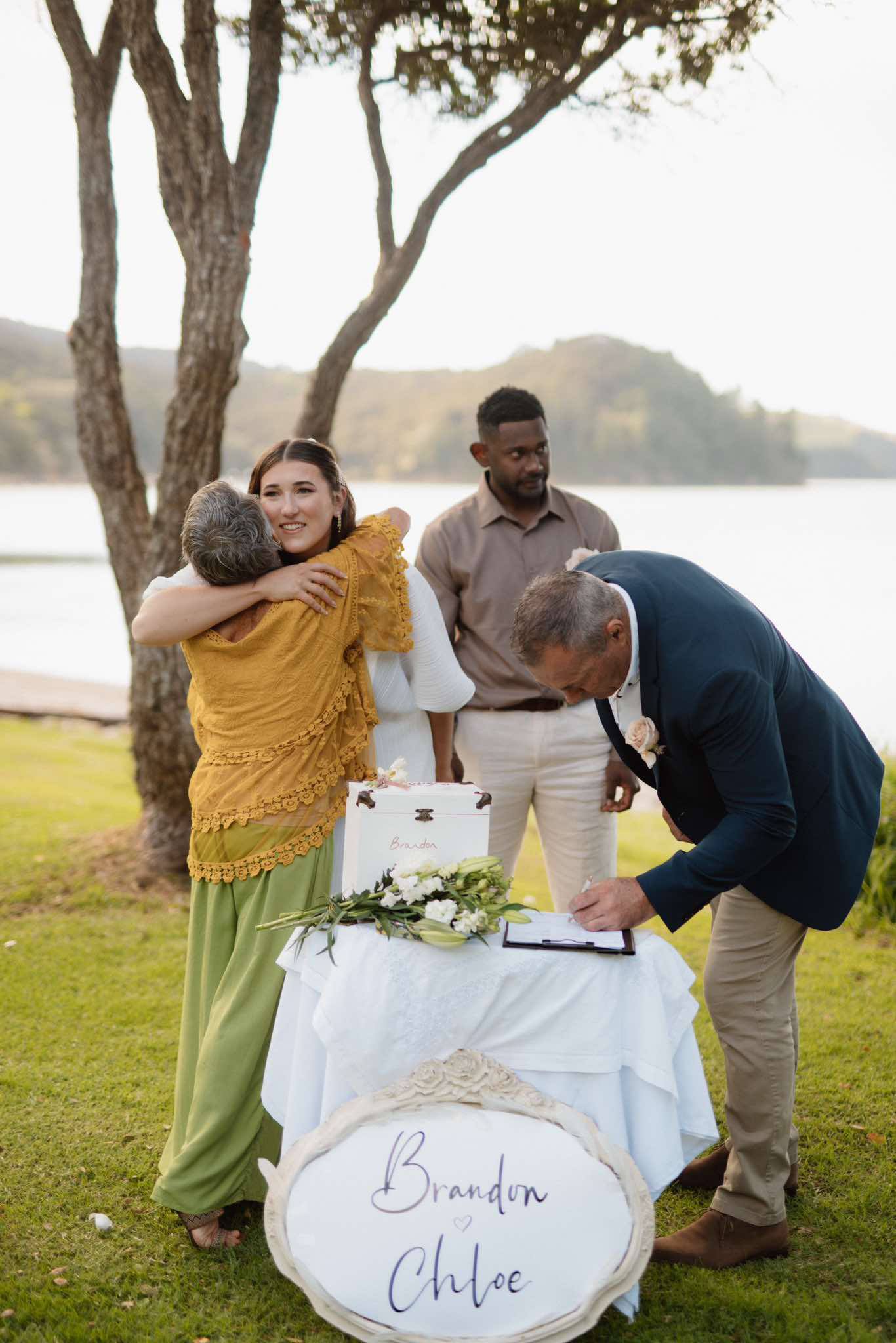 Chloe and Brandon signing the marriage register at their Waiheke Island ceremony