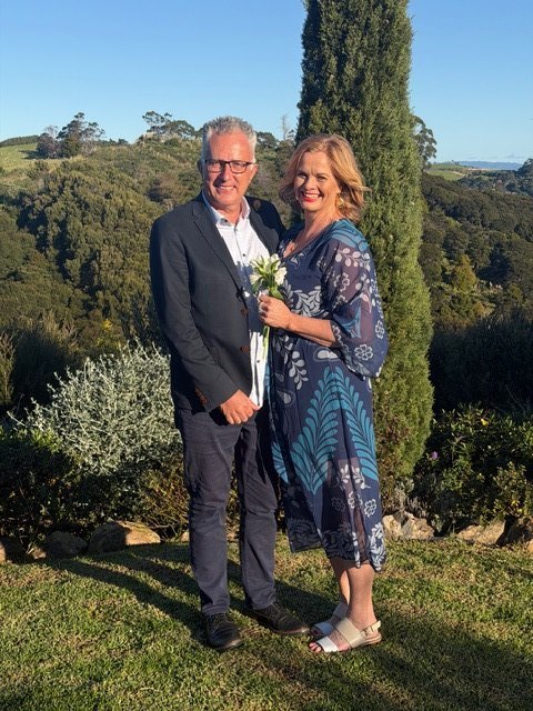 Lucy and Carlos on their wedding day - smiling together in a beautiful Waiheke Island vineyard setting