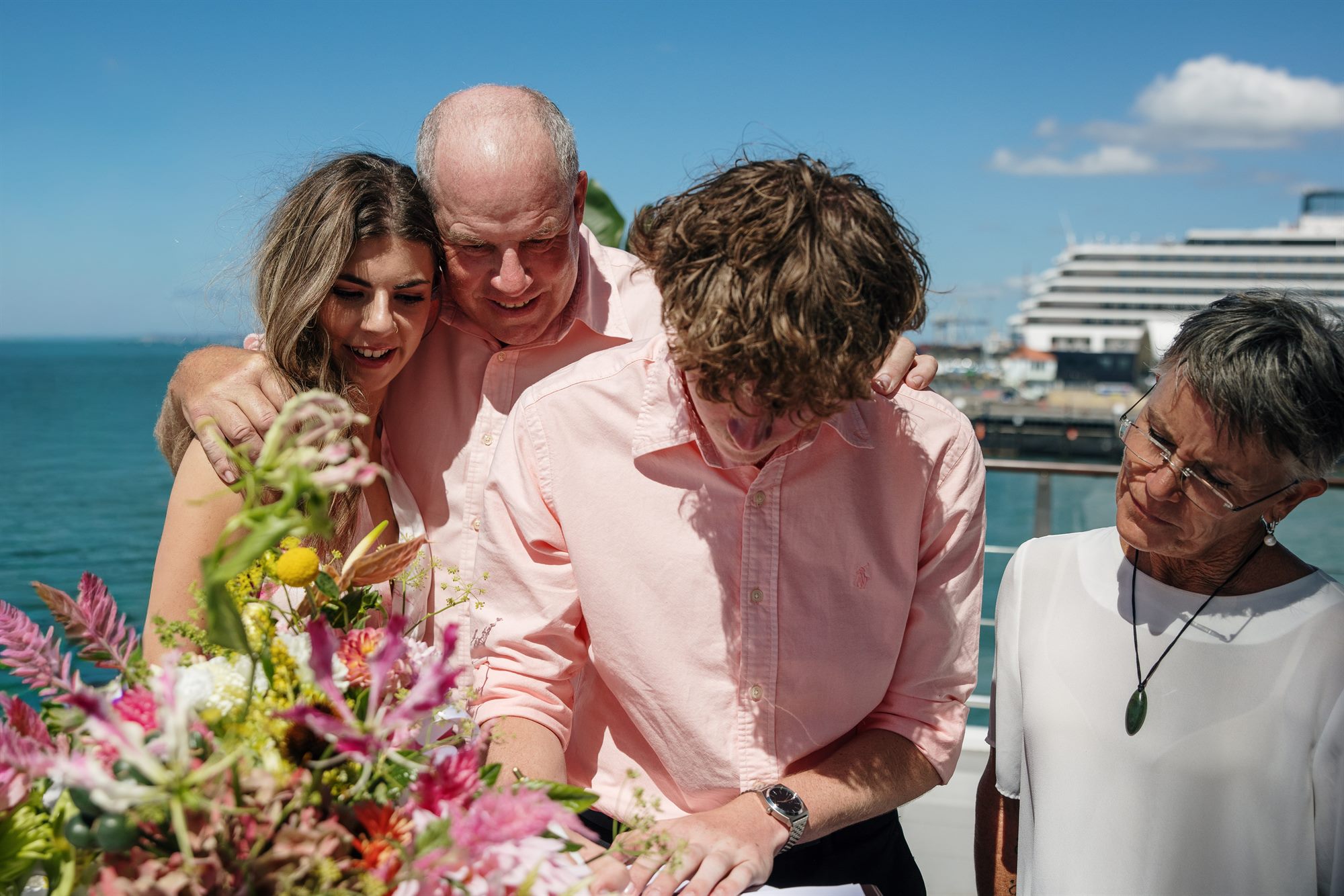 Sue, Pablo and family sharing a joyful moment at the register signing with Linda at their Waiheke Island wedding