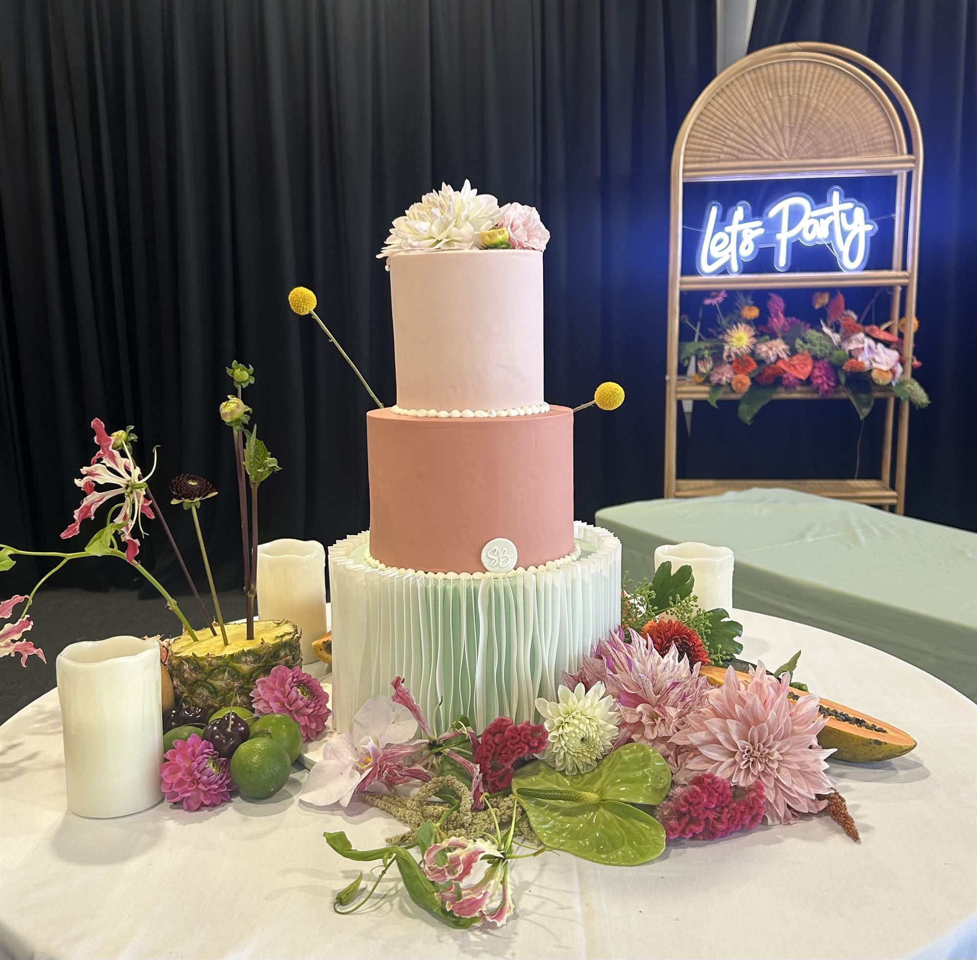 Elegant wedding cake and floral display at a Waiheke Island wedding celebration